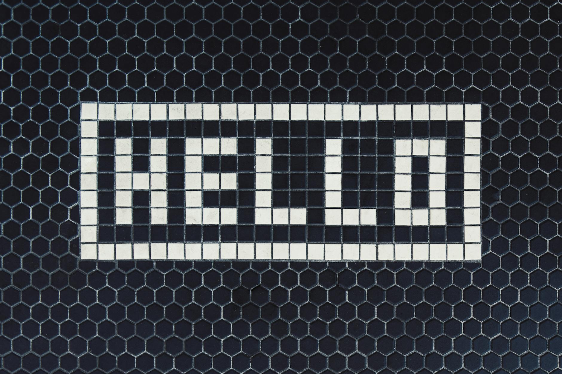 a word hello made from tiles on the wall